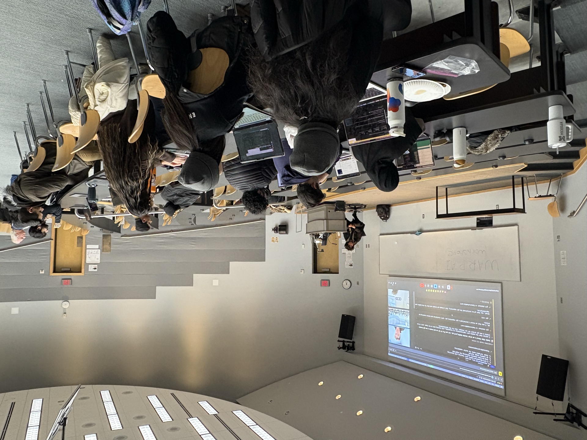 AIC members gathered in a tiered workshop classroom